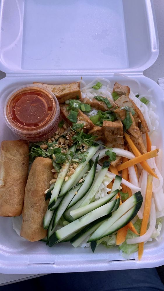 Tofu vermicelli bowl with egg roll and fresh cucumber and carrot